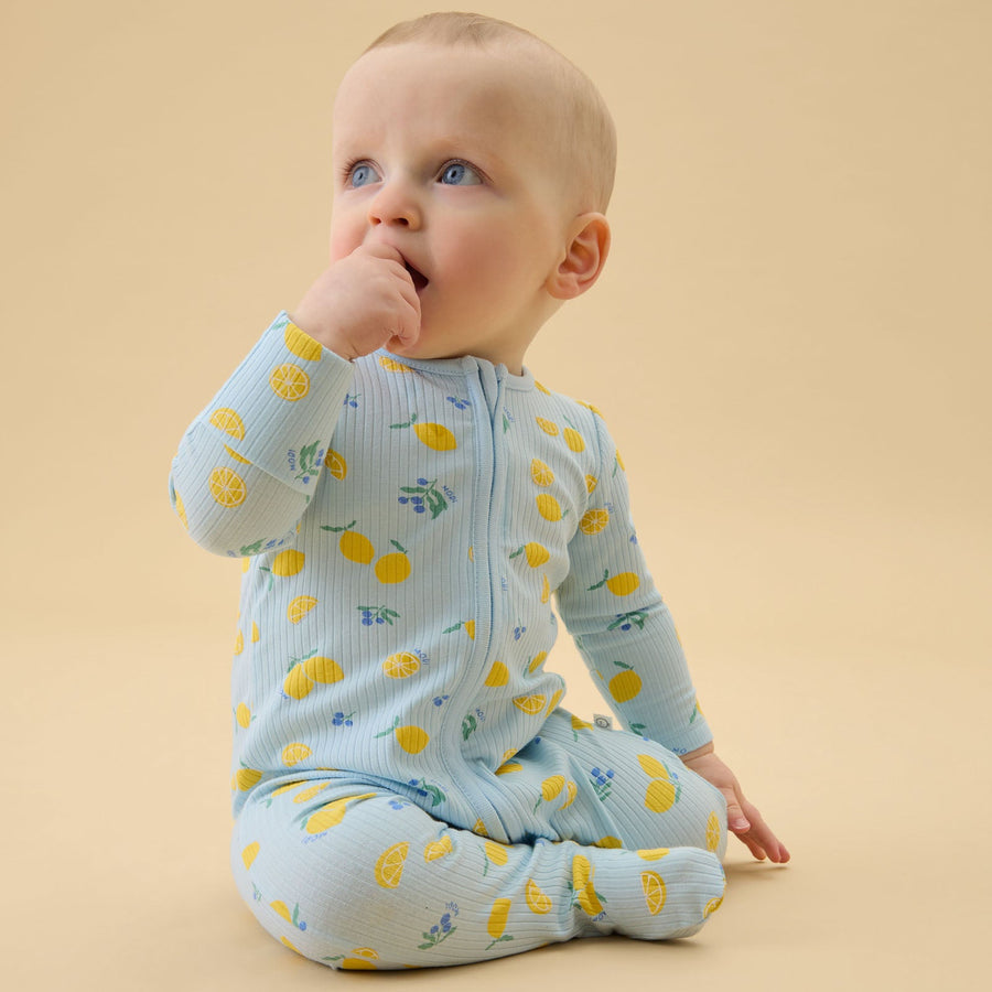 Lemon Lullaby Ribbed Zip Sleepsuit on a baby